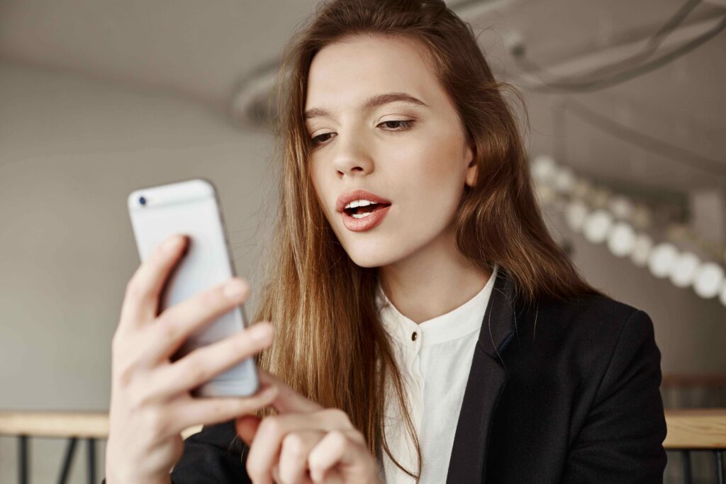 gorgeous-young-woman-using-mobile-phone-co-working-space_11zon